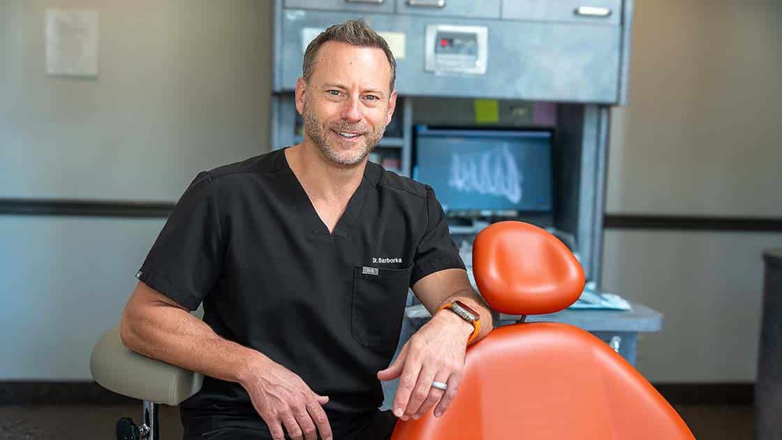 Dr. BARBORKA posing by exam chair