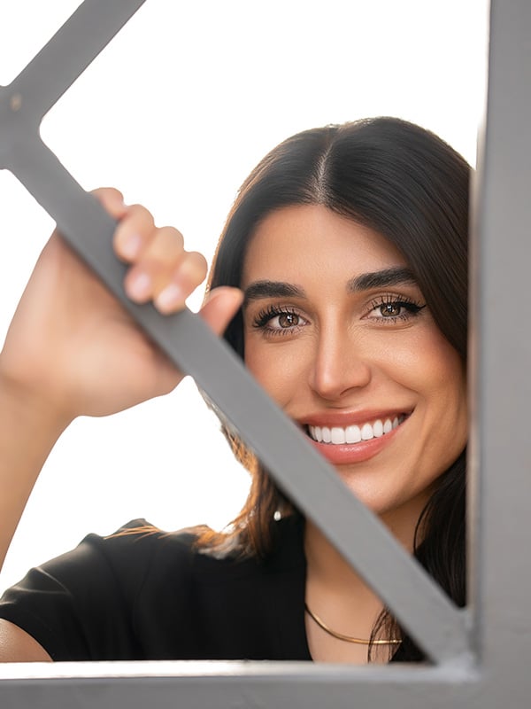 Dr Rezaei in window smiling